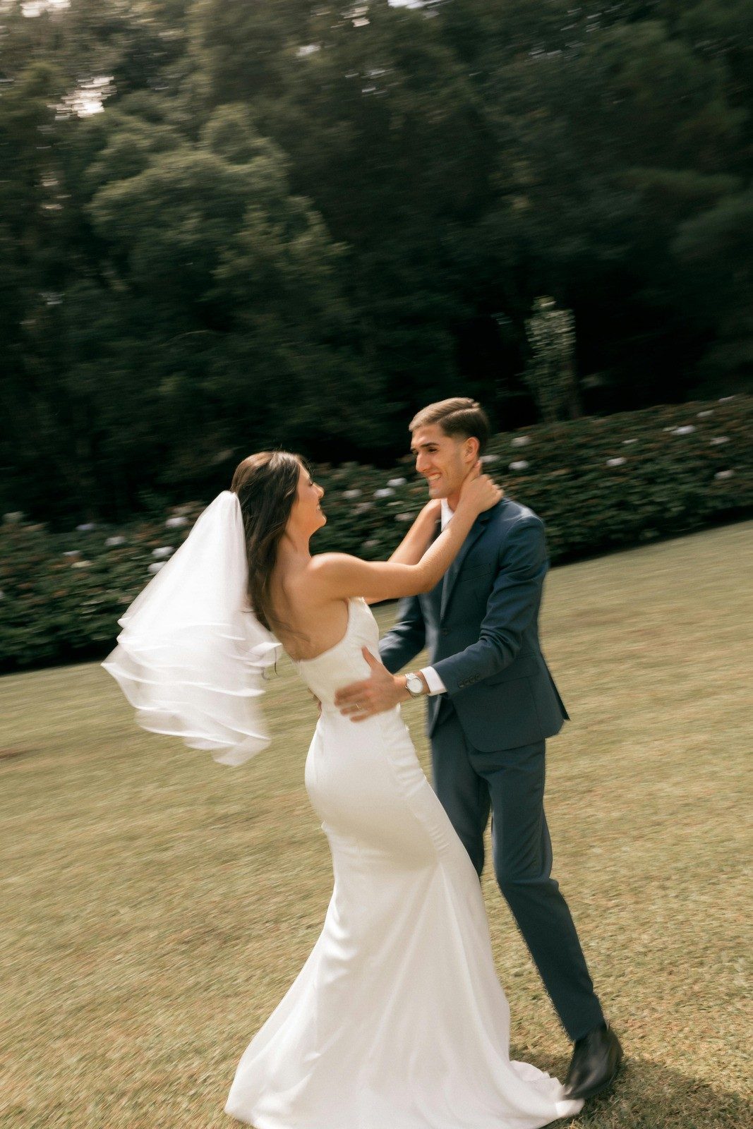 Joyful Bride and Groom Dancing in Garden