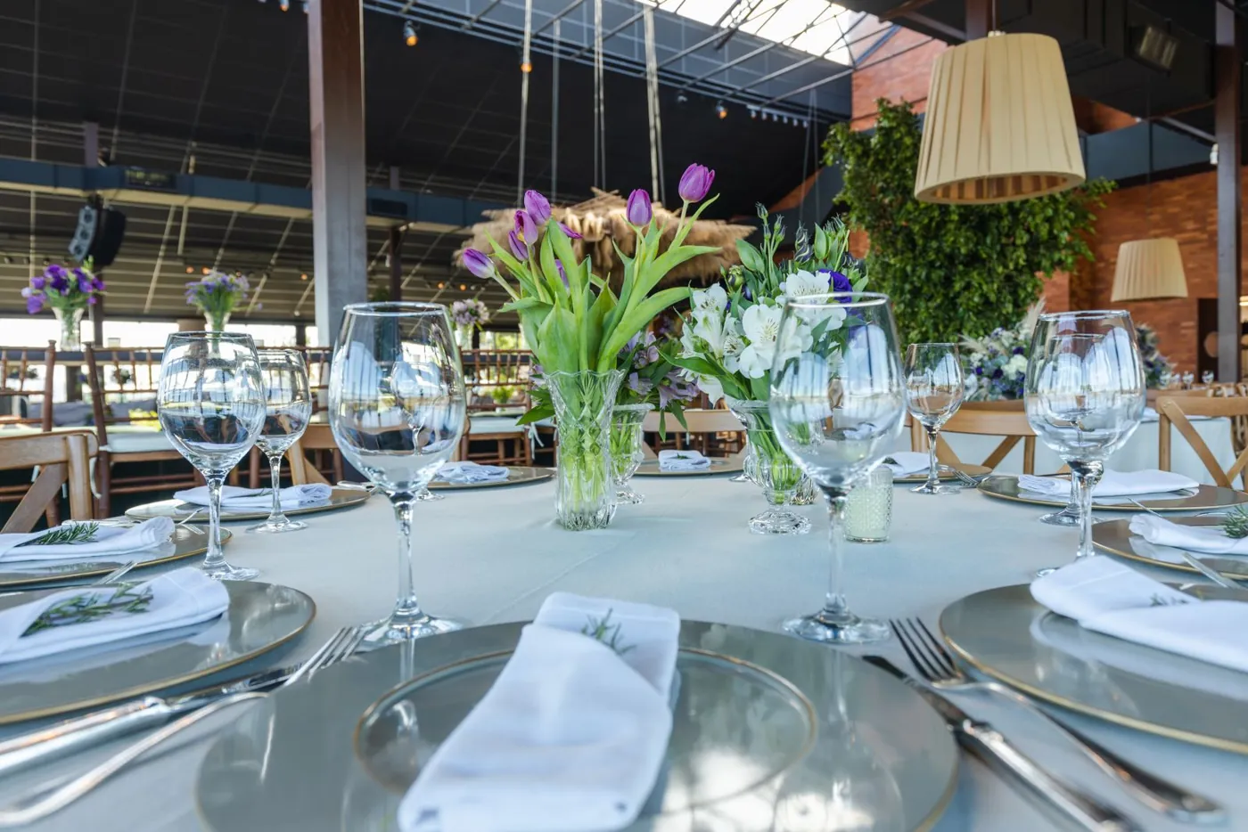 A beautifully arranged table setting featuring glassware and floral centerpiece for a wedding reception. Licensed inspiration image; not a BMG client portfolio claim.