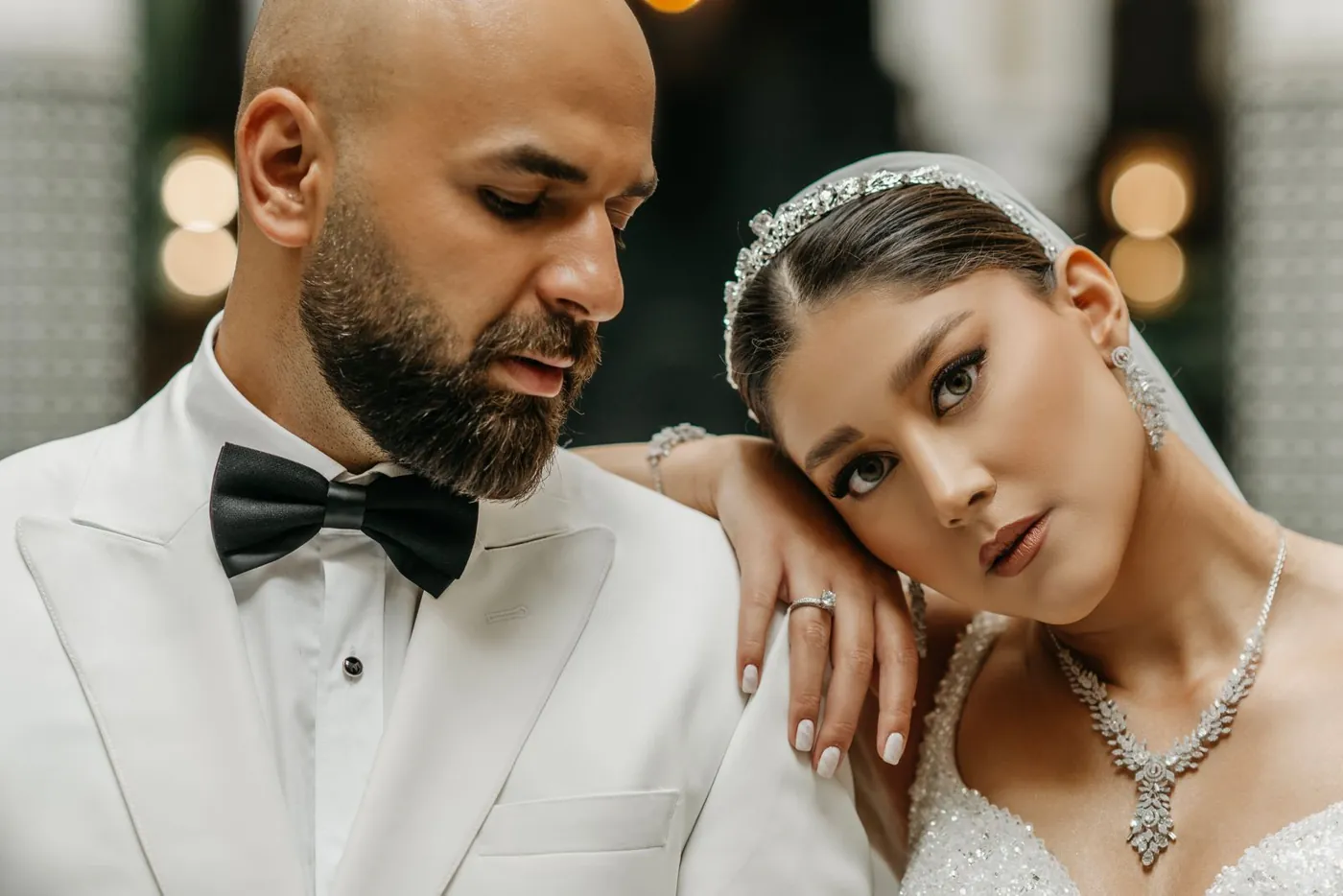 Elegant portrait of a bride and groom in a sophisticated setting, showcasing love and elegance. Licensed inspiration image; not a BMG client portfolio claim.