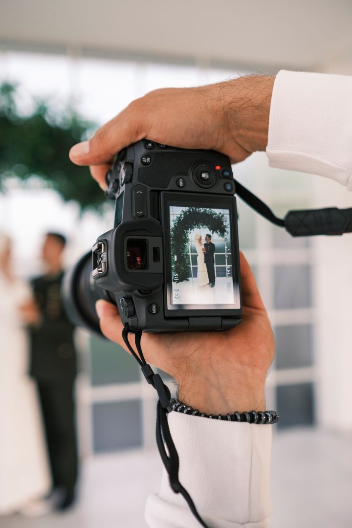 close up of a viewfinder of a camera photographing bride and groom Licensed inspiration image; not a BMG client portfolio claim.