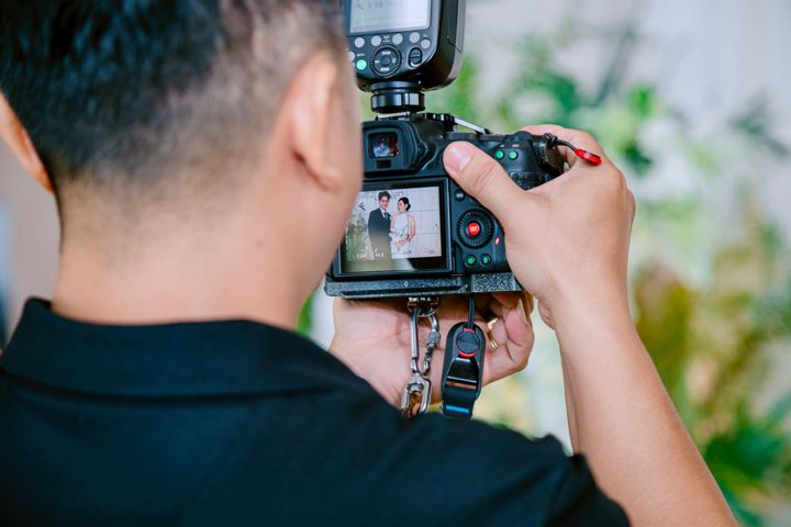 photographer captures wedding moment on camera Licensed inspiration image; not a BMG client portfolio claim.